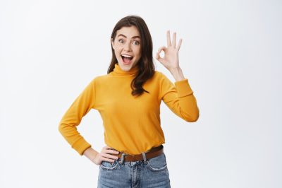 excited-young-woman-advertising-good-product-showing-ok-sign-say-yes-approve-something-cool-praise-awesome-choice-standing-happy-against-white-wall